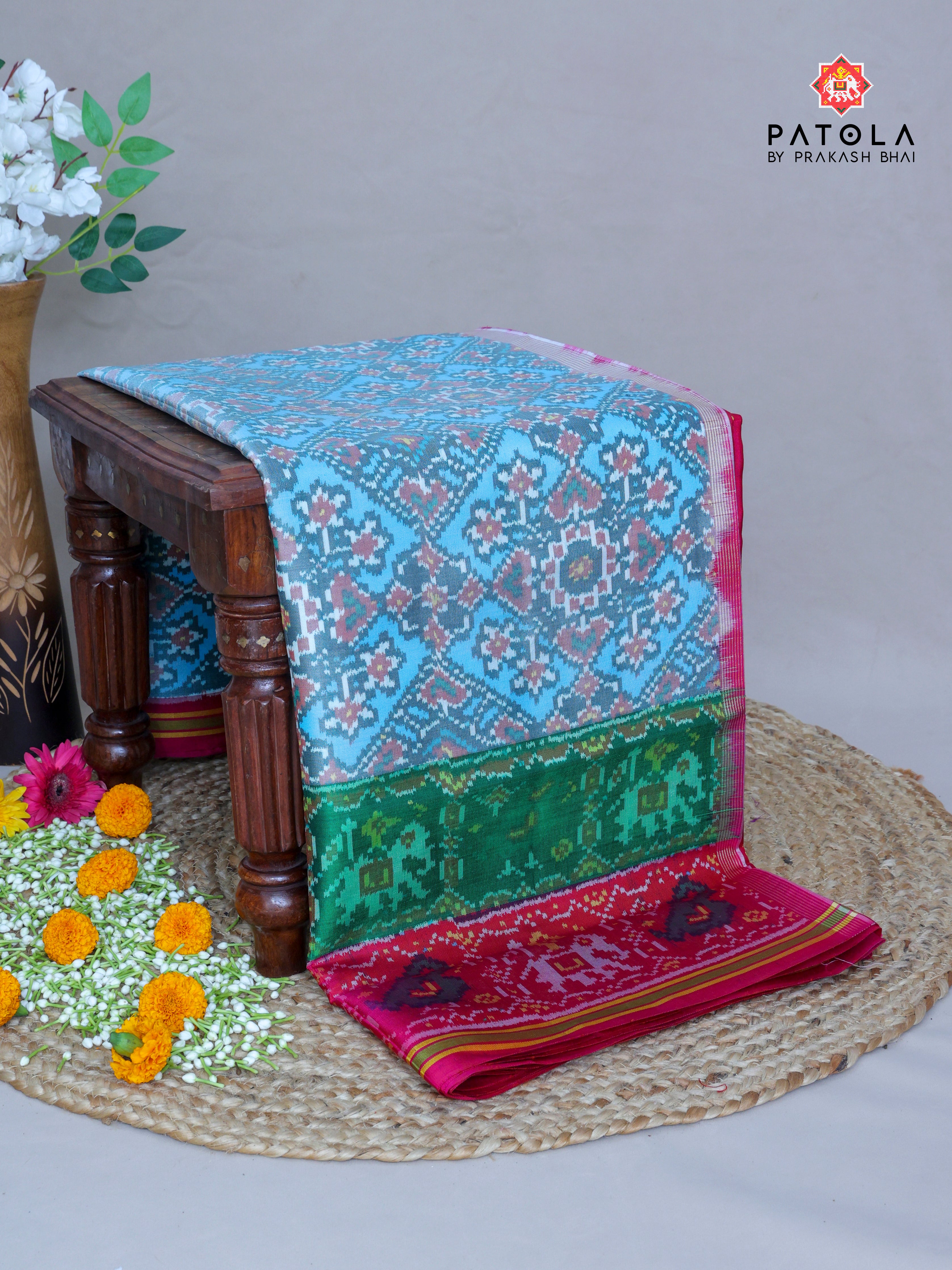 Navratna Pan Chanda Mix Design With Two Colors Border Semi Double Ikat Patola Saree