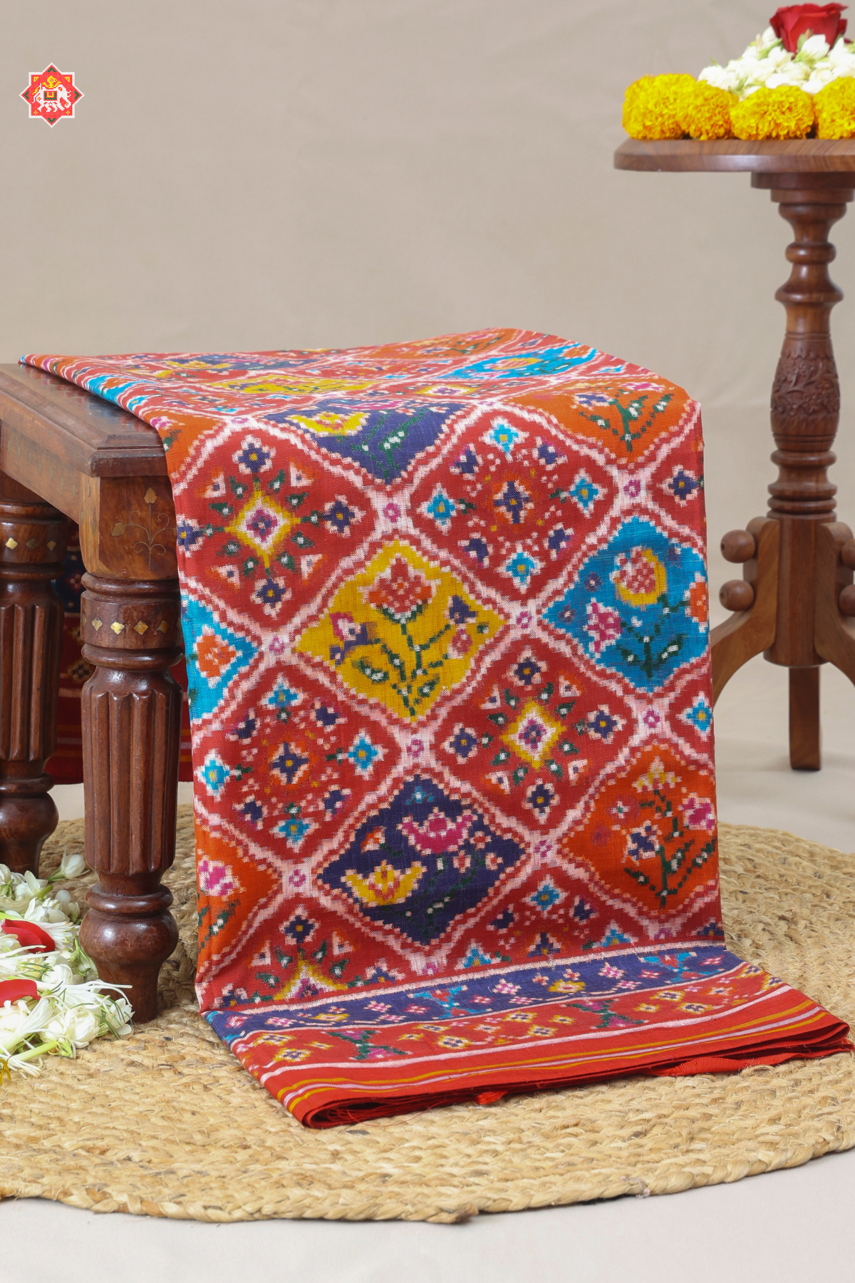 "Patan patola the pardah motif (curtain design) with its array of regal animal and  stylized floral figures,captures in a traditional geometric field."