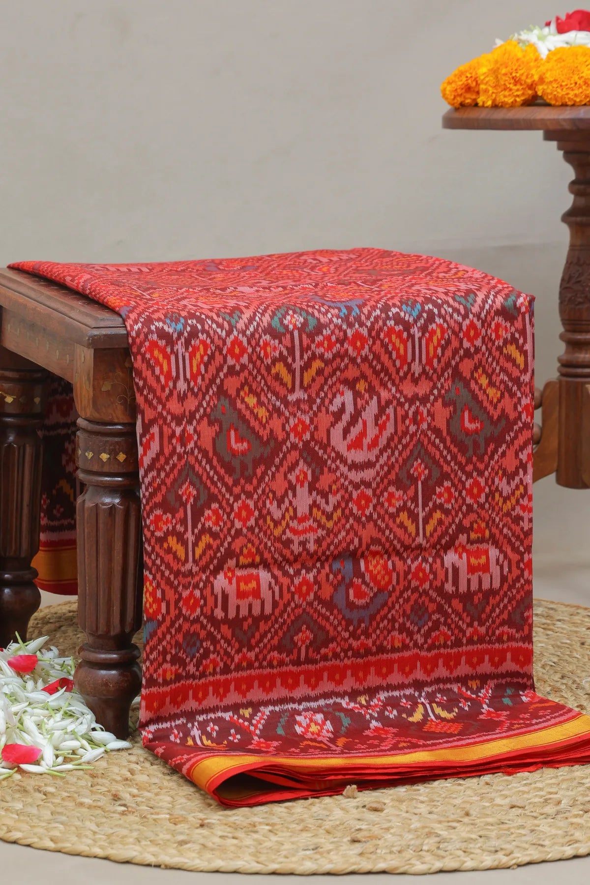 Traditional nari kunjar design with ghughroo border single ikat patola saree