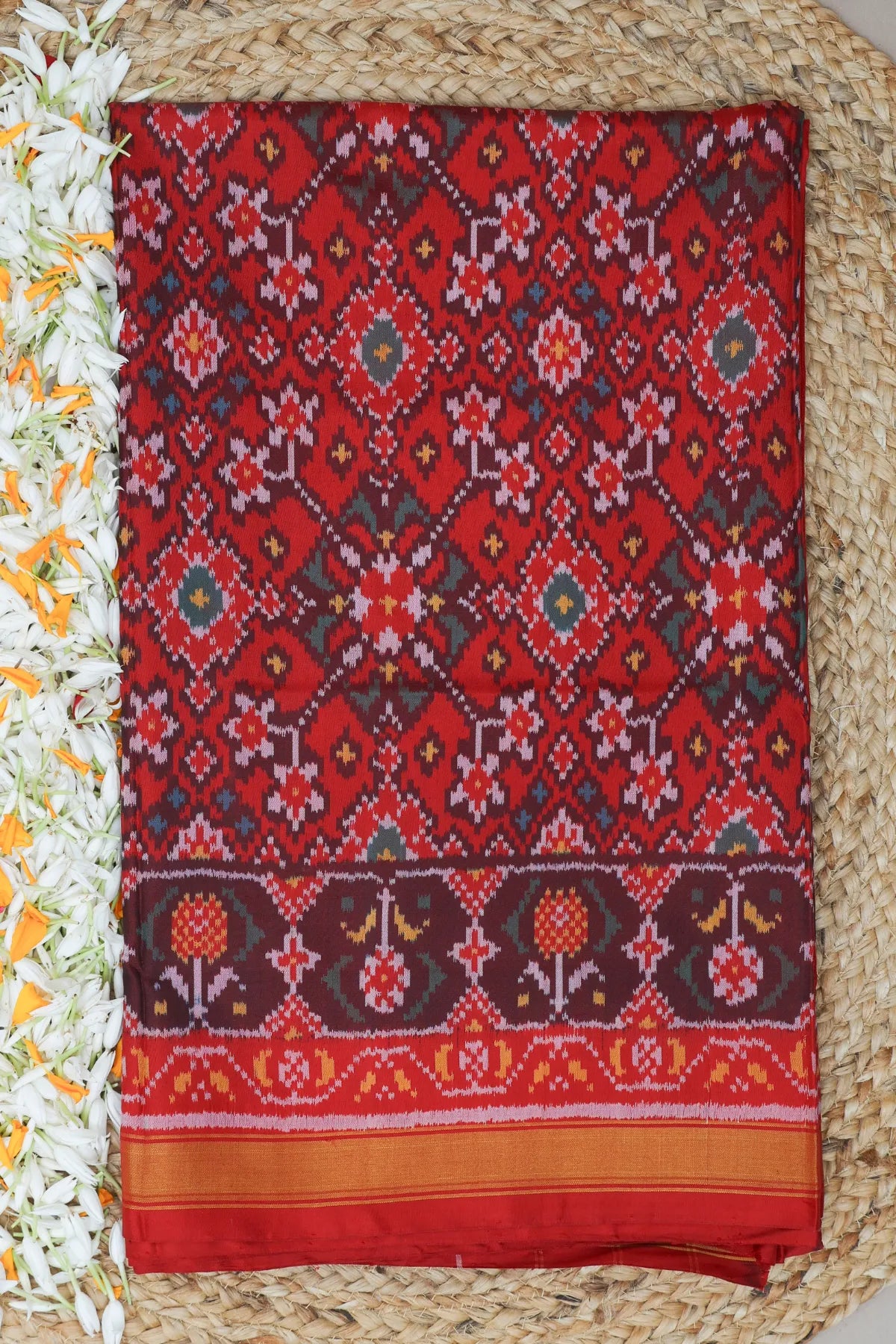 Traditional navratna design small tissue border single ikat patola saree