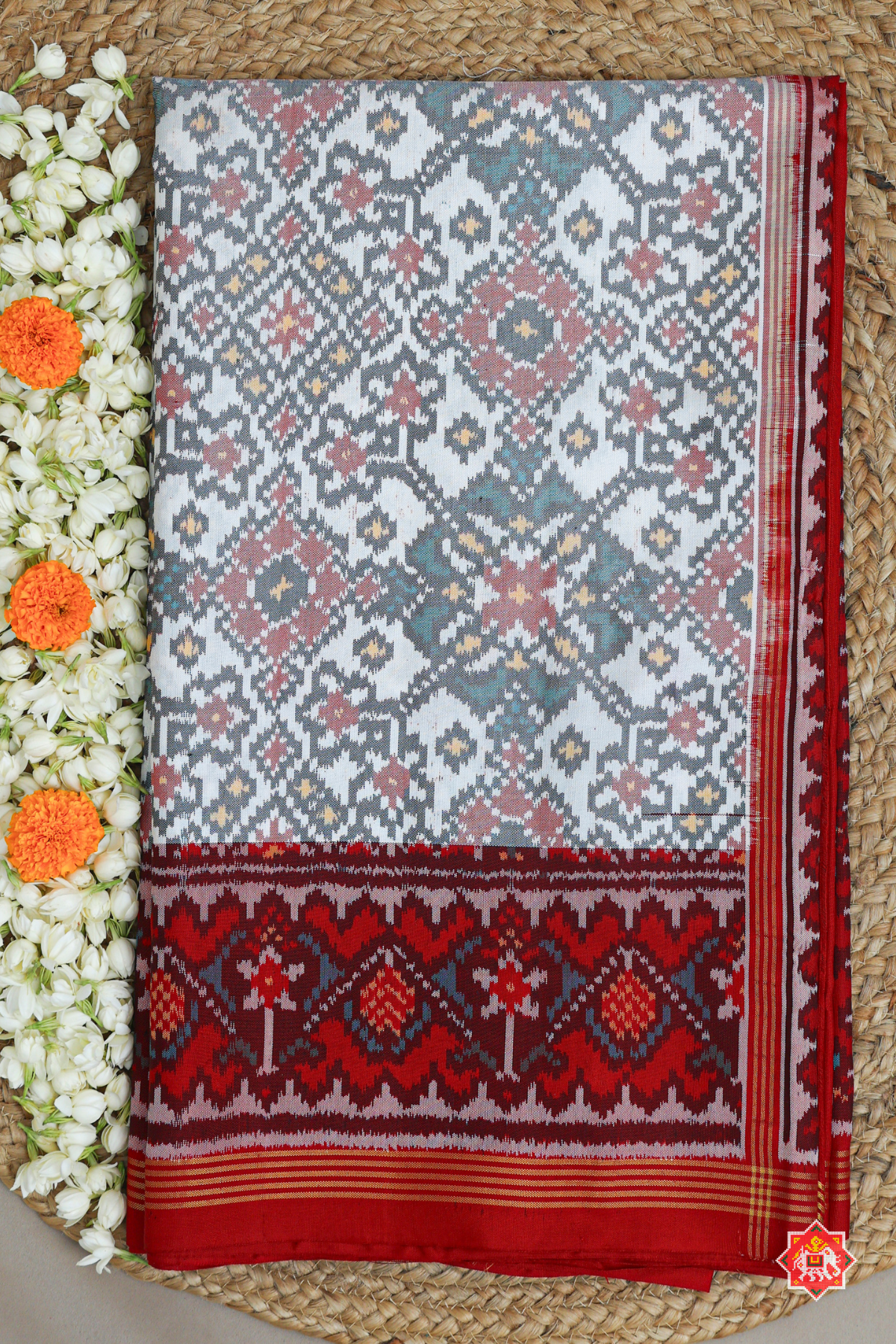 Traditional navratn design with minakari work pallu border contras semi double ikat patola saree