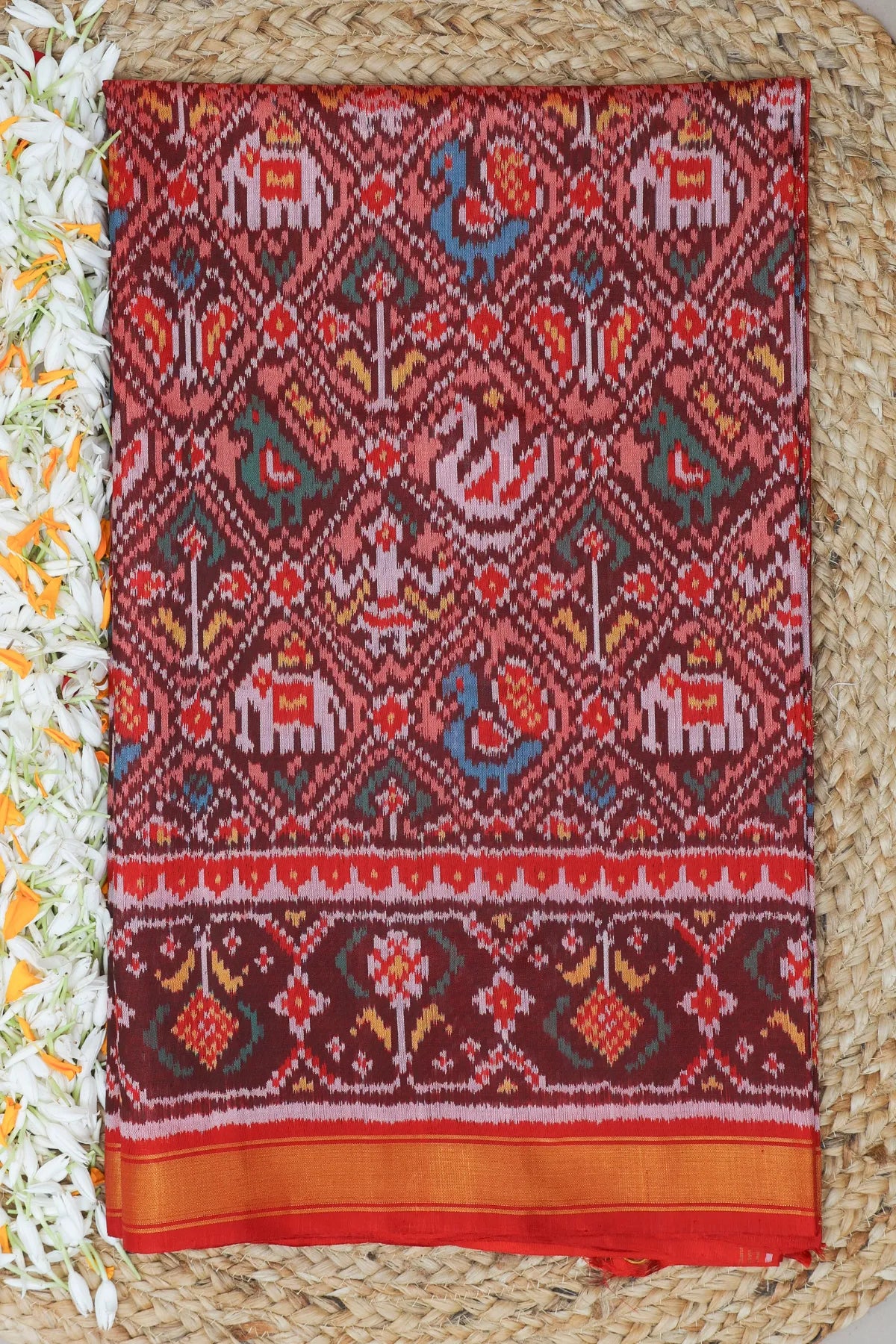 Traditional nari kunjar design with ghughroo border single ikat patola saree