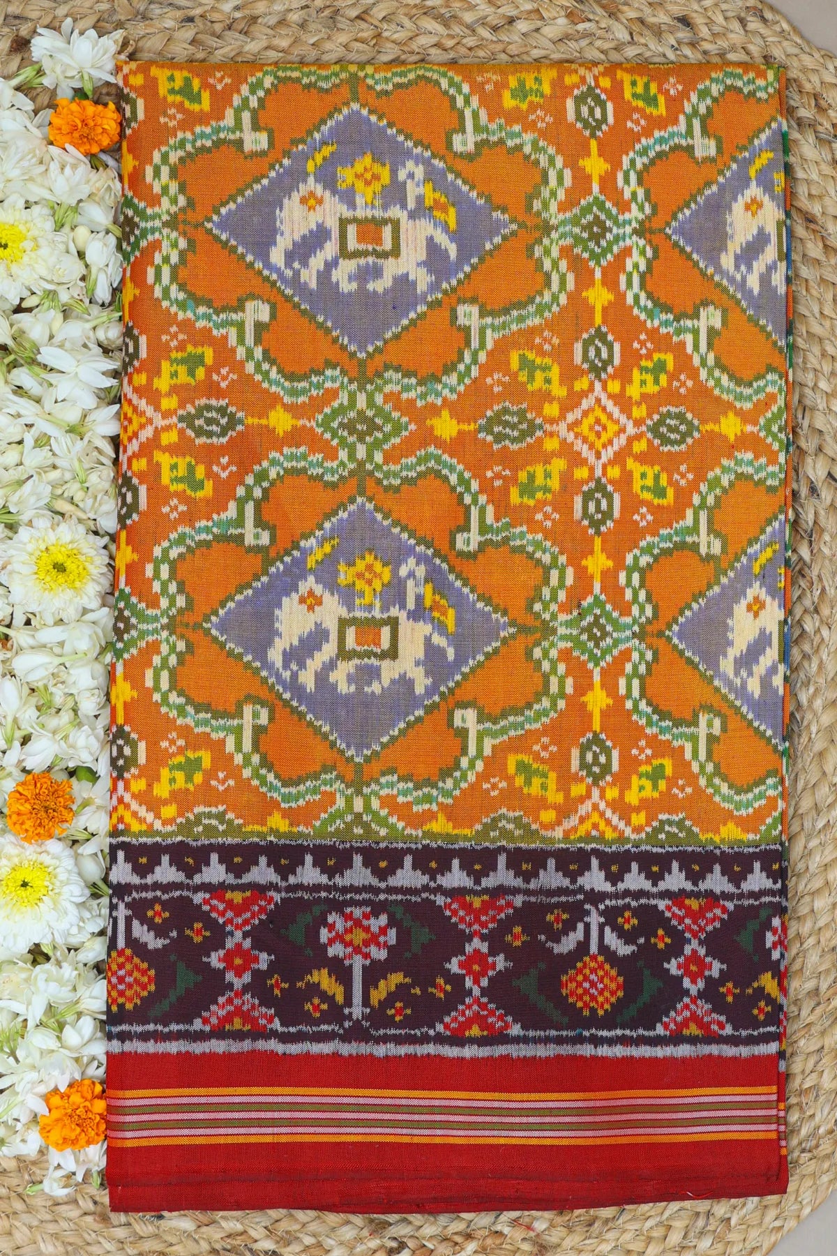 Rangoli design with elephant & pallu border ghughroo design semi double ikat patola saree