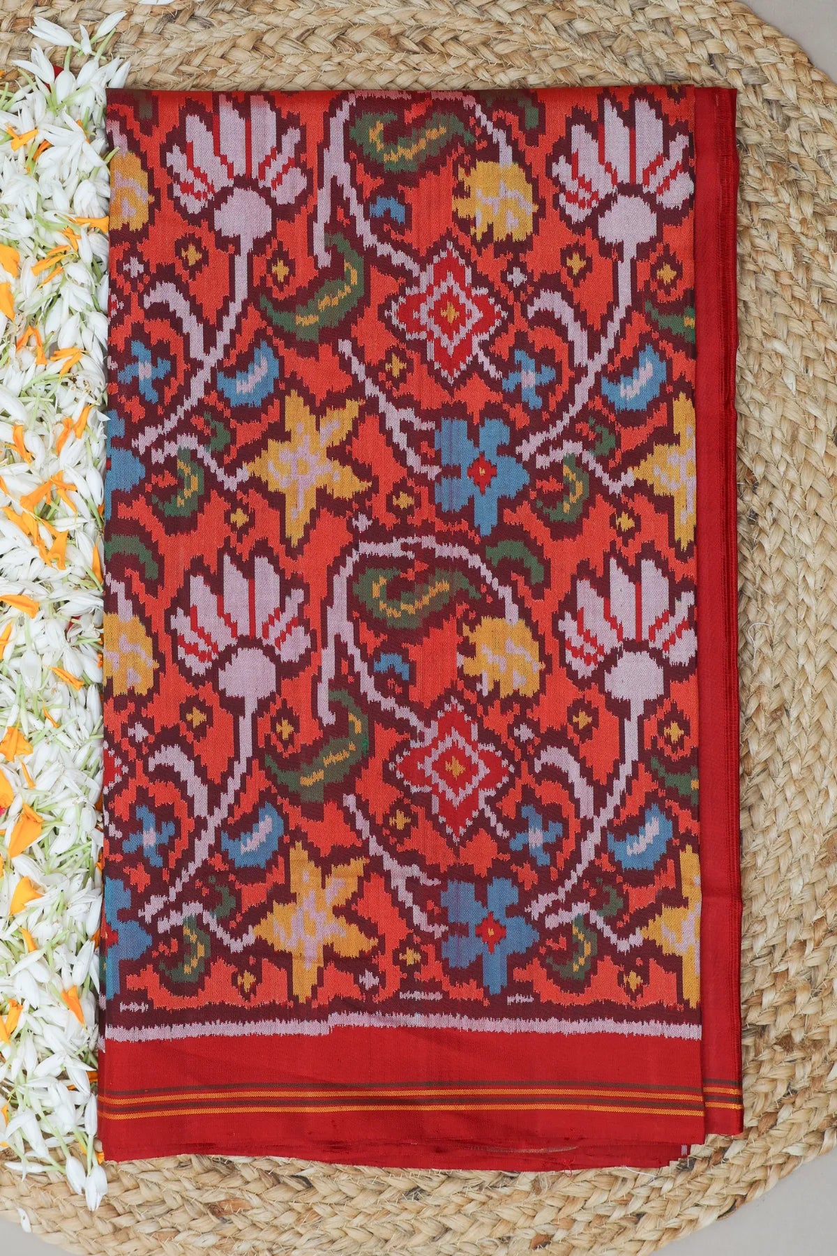 Masterpiece rangoli design with lines border traditional pallu design semi double ikat patola saree