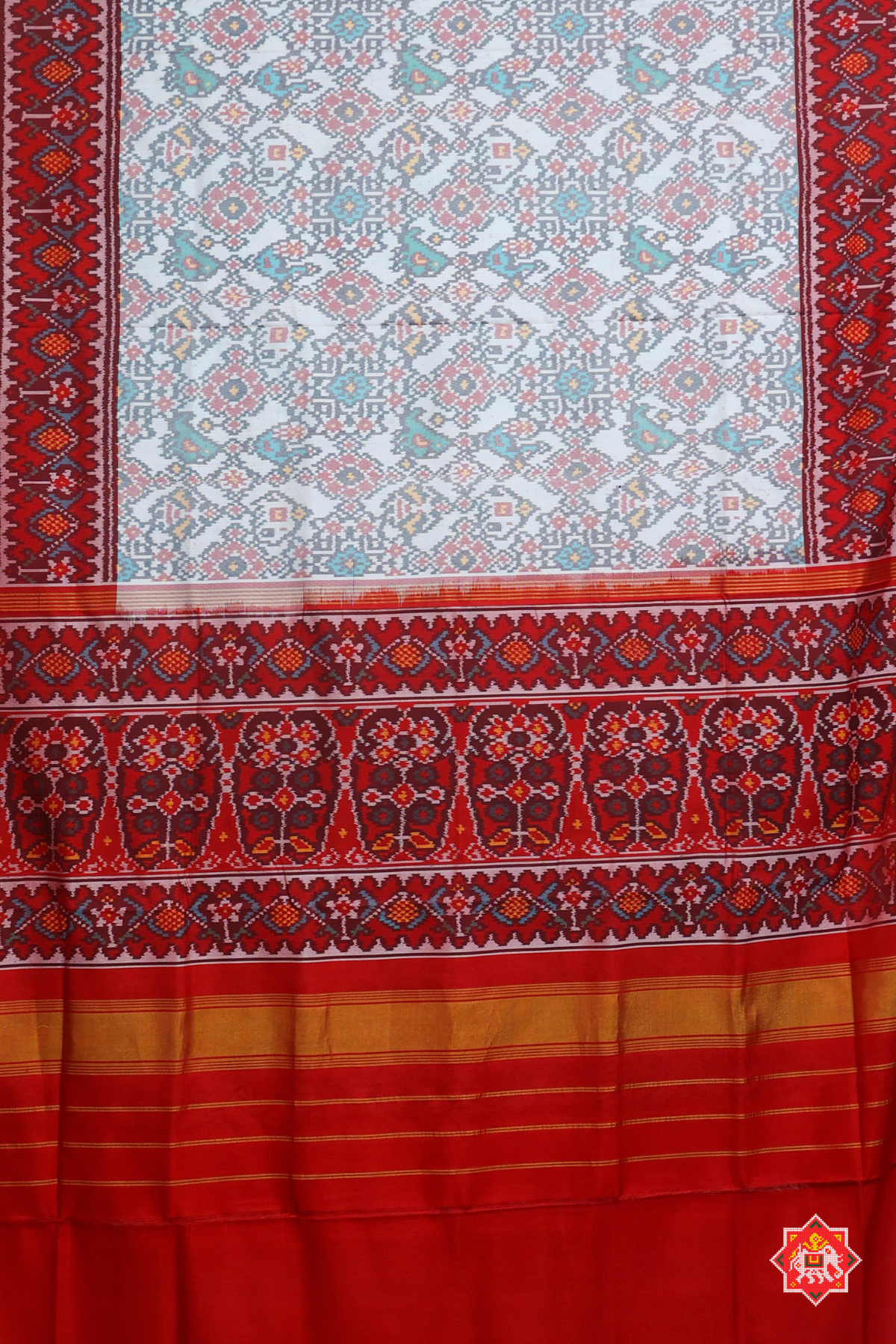 Traditional navratn design with small motif design semi double ikat patola saree