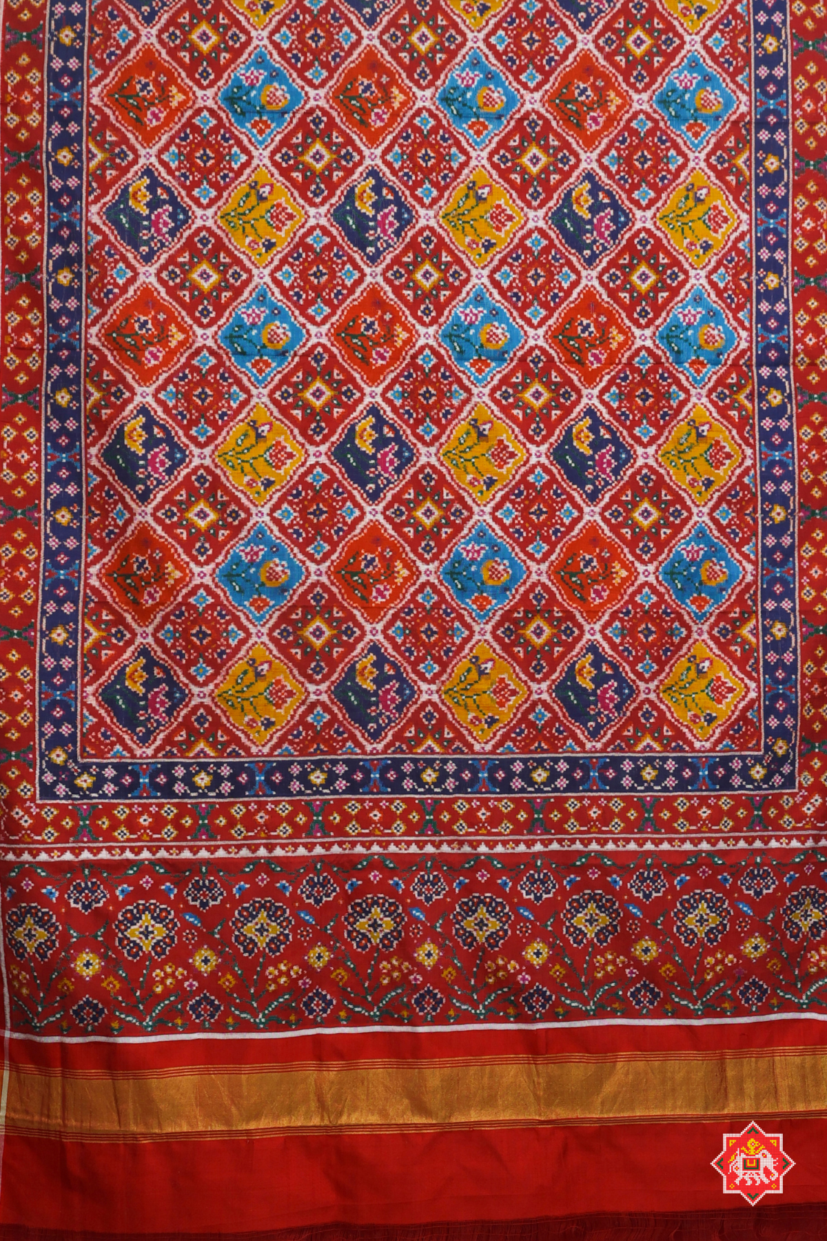 "Patan patola the pardah motif (curtain design) with its array of regal animal and  stylized floral figures,captures in a traditional geometric field."
