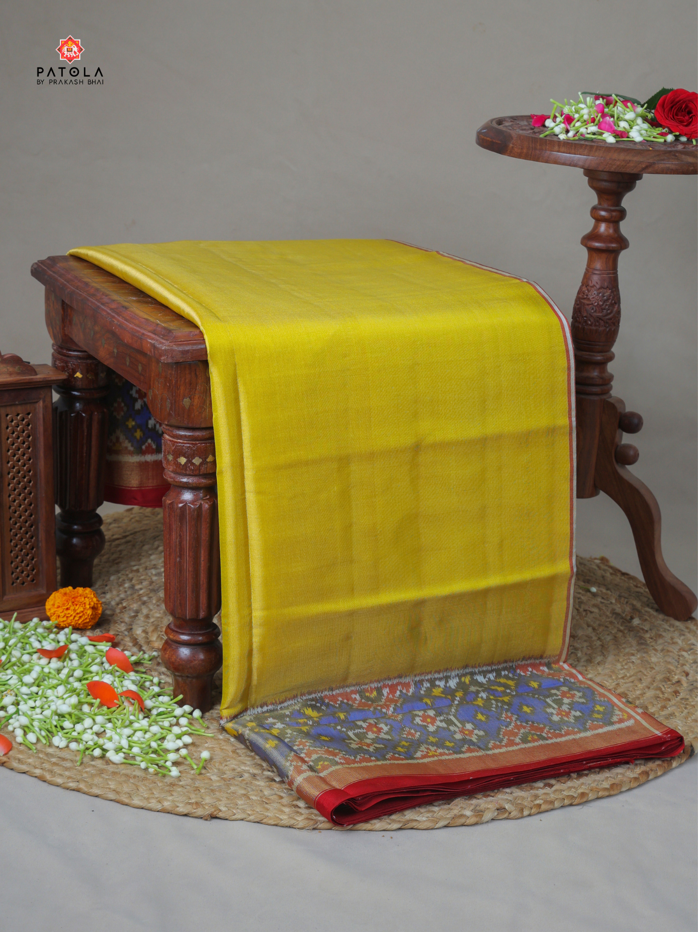 Plain Yellow with navratna border tissue patola saree